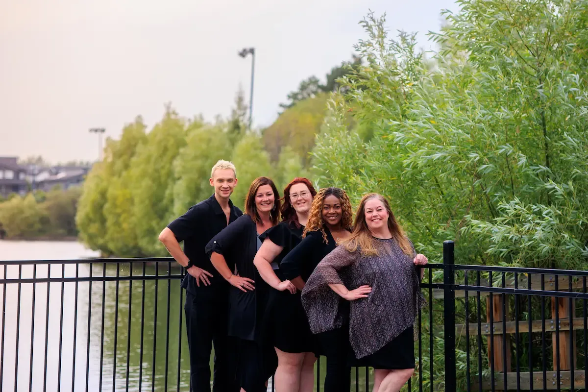 Team portrait at the railing by the water