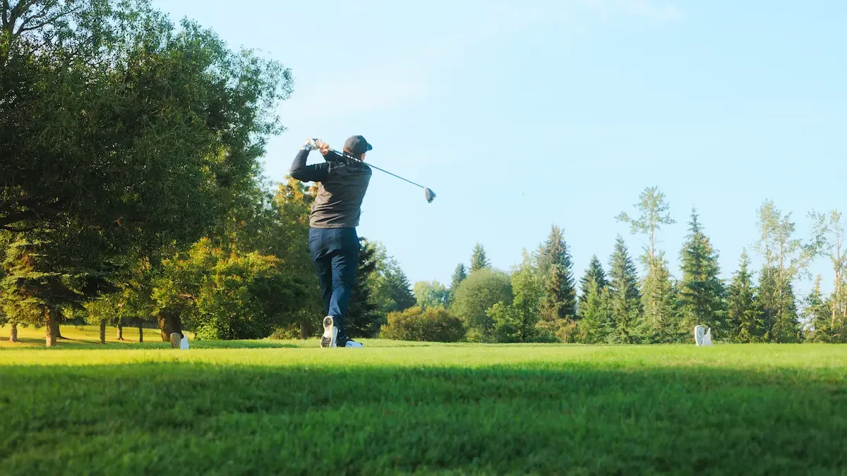 Golfer tee shot at Sturgeon Valley Golf Club